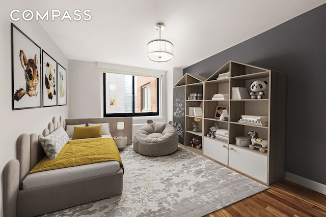 sitting room featuring baseboards and wood finished floors