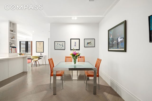 dining area featuring baseboards