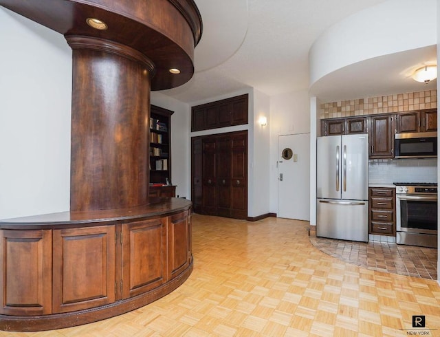 interior space featuring appliances with stainless steel finishes and backsplash