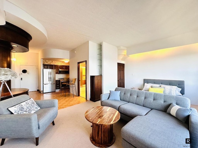 living room featuring a textured ceiling and light parquet flooring