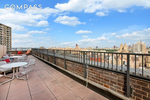 view of patio featuring a city view and a balcony