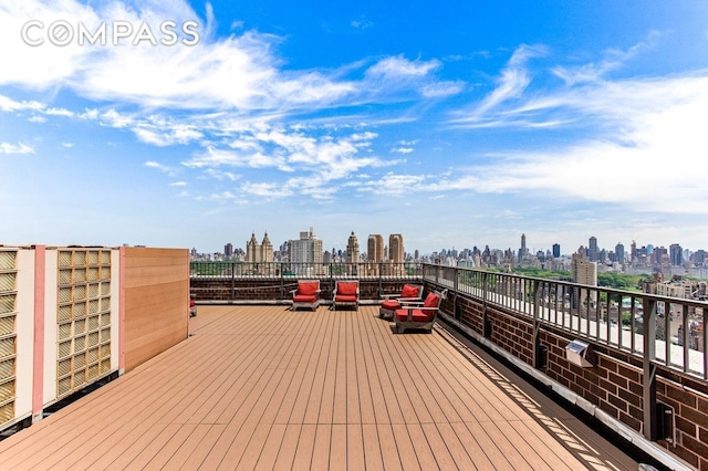wooden terrace featuring a skyline view
