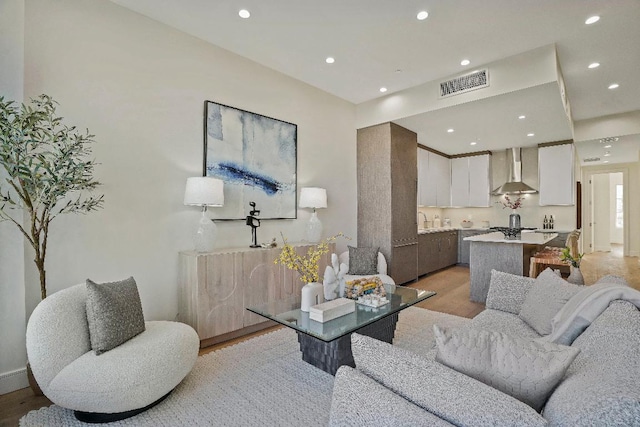 living room featuring light wood-type flooring and sink