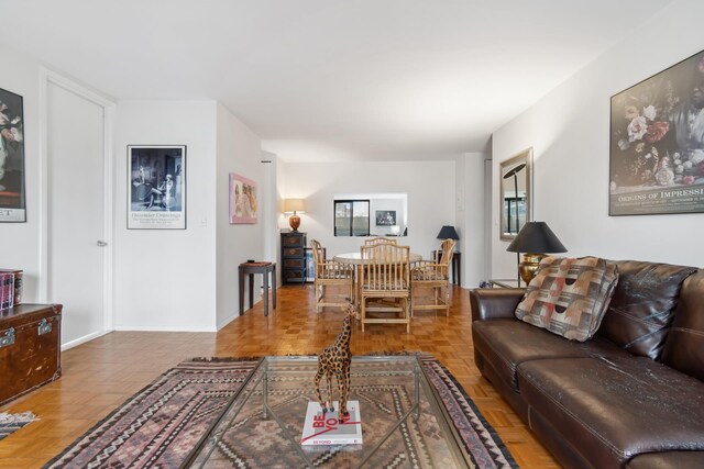 living room with ceiling fan, parquet flooring, and floor to ceiling windows