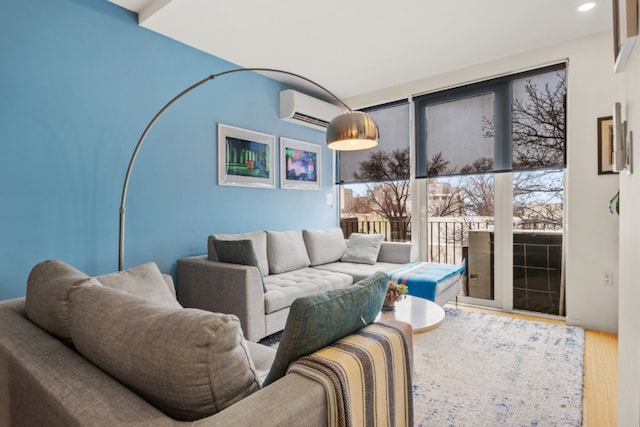 living room with a wall mounted AC and wood-type flooring