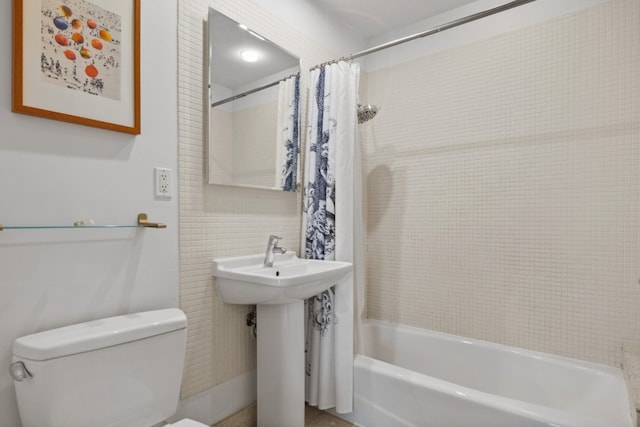 full bathroom with toilet, sink, and shower / tub combo with curtain