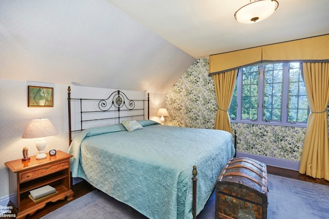 bedroom featuring vaulted ceiling and dark hardwood / wood-style flooring