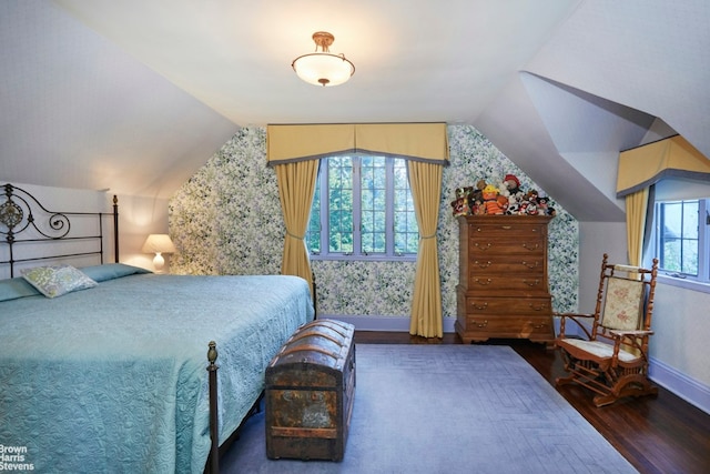 bedroom with lofted ceiling and dark hardwood / wood-style flooring