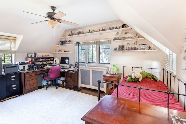 office area with ceiling fan, a healthy amount of sunlight, lofted ceiling, and radiator heating unit