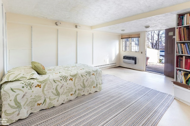 bedroom featuring heating unit, access to outside, a textured ceiling, and baseboard heating