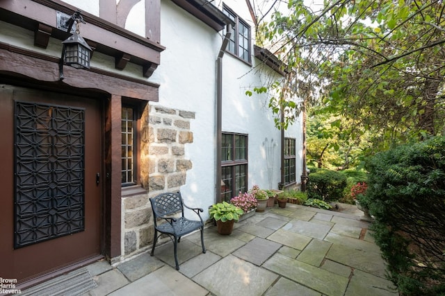 view of exterior entry featuring a patio