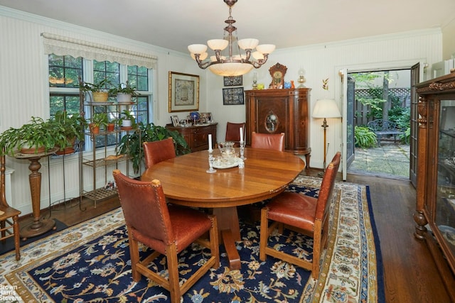 dining room with an inviting chandelier, dark hardwood / wood-style floors, and crown molding