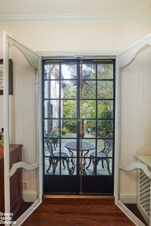 entryway featuring french doors, ornamental molding, and dark wood-type flooring