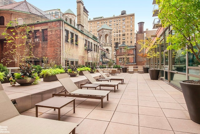 view of property's community featuring an outdoor living space and a patio