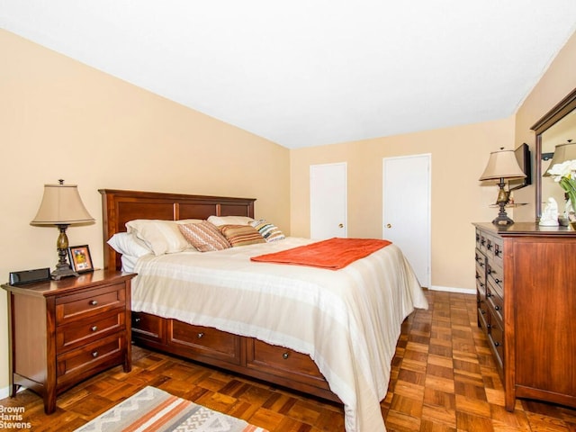 bedroom with dark parquet flooring