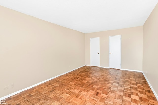 unfurnished room with light parquet flooring