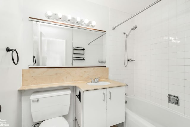 full bathroom with vanity, tiled shower / bath combo, and toilet