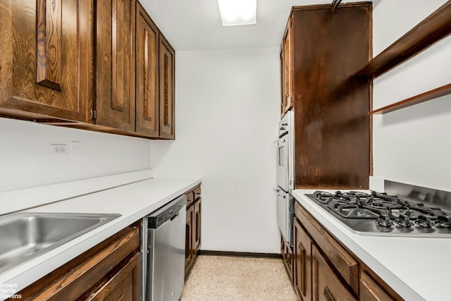 kitchen featuring sink, stainless steel appliances, and a textured ceiling