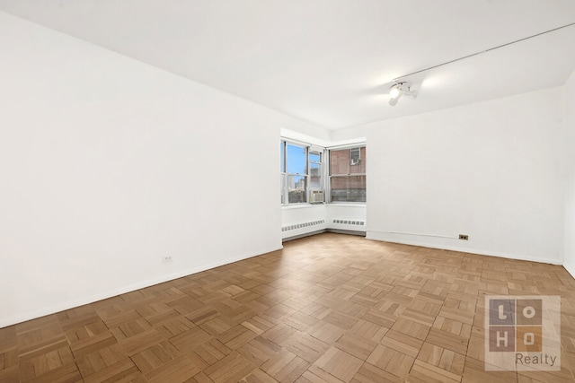 unfurnished room with baseboards