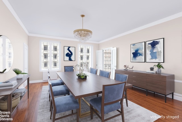 dining space featuring radiator, crown molding, a chandelier, and hardwood / wood-style floors