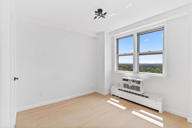 1655 Flatbush Ave Unit B1806, New York City, NY 11210 - unfurnished room featuring a baseboard heating unit, light wood-style floors, and a wall unit AC