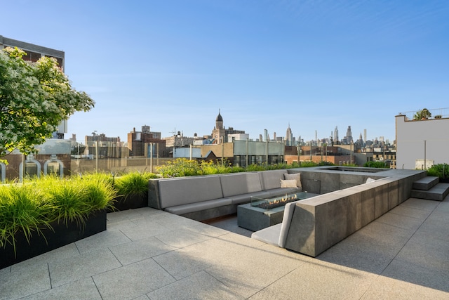 view of patio featuring a view of city and a fire pit