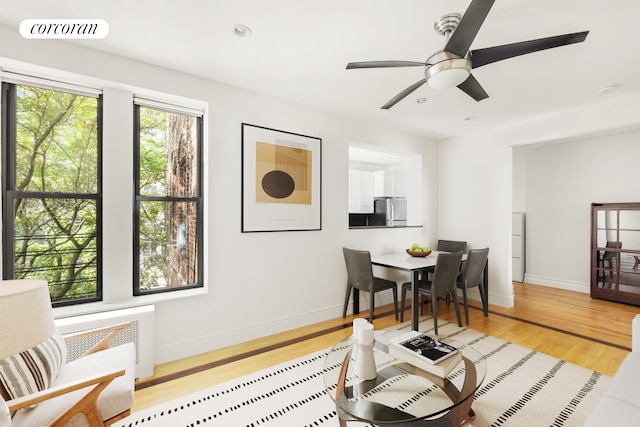 living area with ceiling fan, recessed lighting, visible vents, baseboards, and light wood-style floors