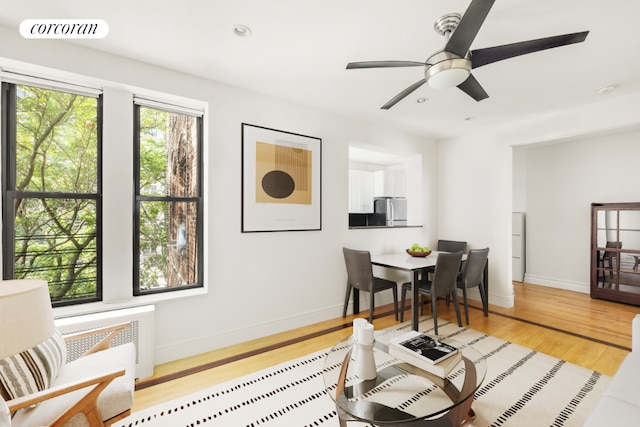 interior space with ceiling fan and light hardwood / wood-style flooring