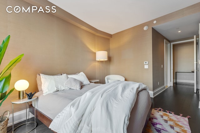 bedroom featuring baseboards and wood finished floors