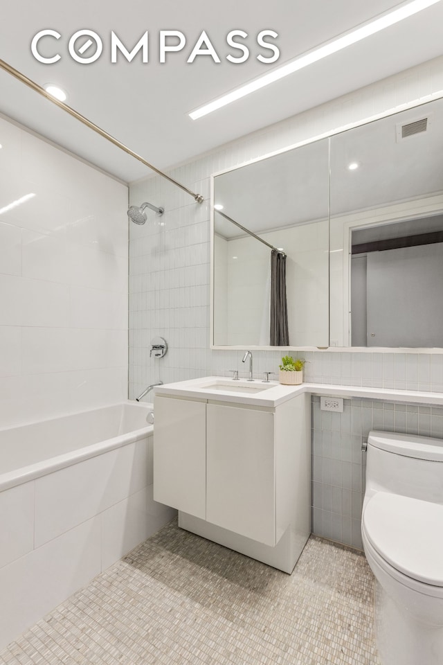 50 Riverside Blvd Unit 19F, New York City, NY 10069 - bathroom with tile walls, tiled shower / bath, vanity, toilet, and tile patterned floors
