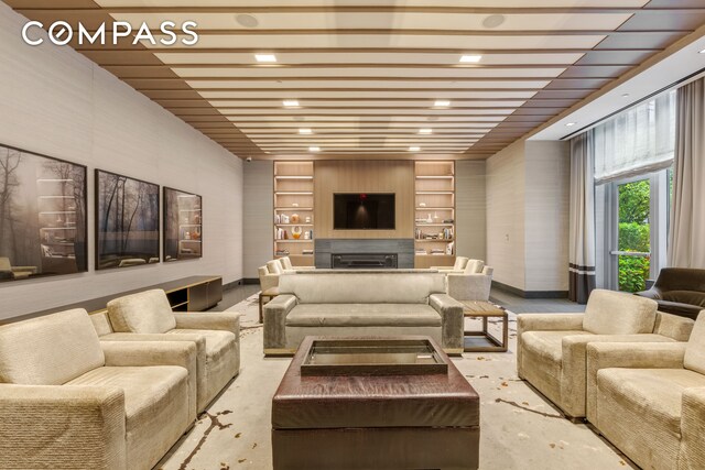 50 Riverside Blvd Unit 19F, New York City, NY 10069 - living room with recessed lighting, built in shelves, baseboards, a fireplace, and concrete floors