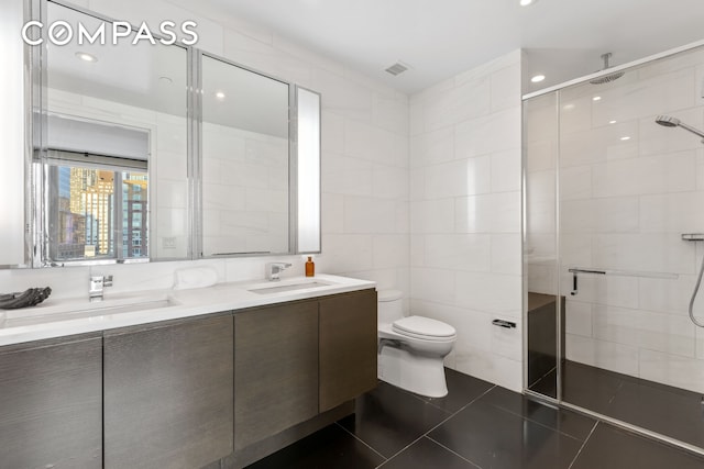 50 Riverside Blvd Unit 19F, New York City, NY 10069 - bathroom with a stall shower, tile walls, double vanity, toilet, and tile patterned flooring