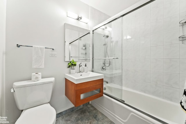 full bathroom featuring bath / shower combo with glass door, toilet, and vanity