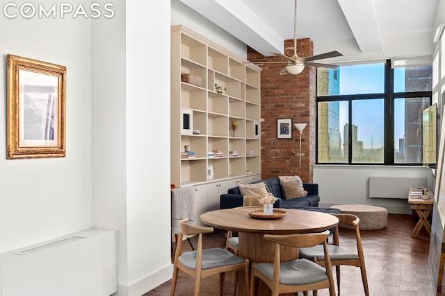 living area featuring ceiling fan, beam ceiling, and breakfast area