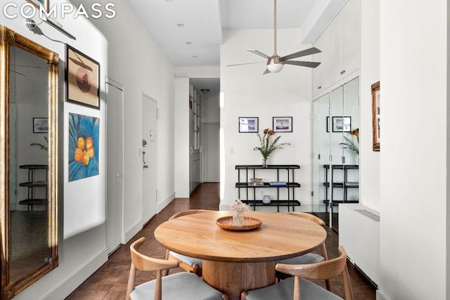 dining room featuring ceiling fan, dark hardwood / wood-style flooring, and radiator heating unit