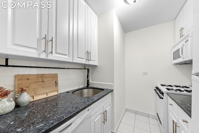 kitchen with tasteful backsplash, sink, white appliances, white cabinetry, and light tile patterned floors