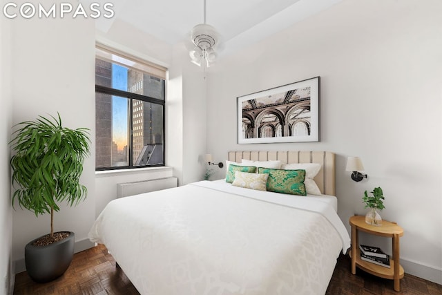 bedroom featuring dark parquet flooring