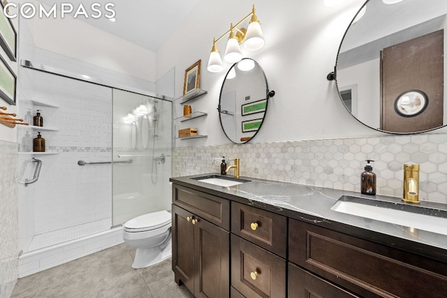 bathroom featuring decorative backsplash, toilet, a shower with shower door, and vanity