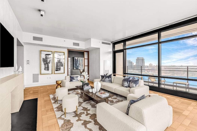 living room featuring expansive windows and light parquet flooring