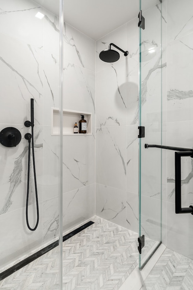 full bath with a marble finish shower