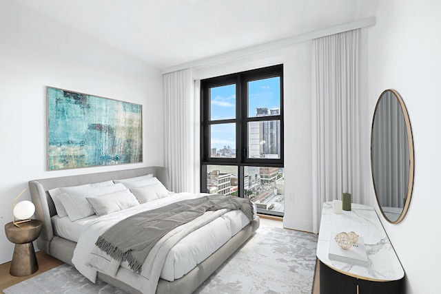 bedroom featuring multiple windows and light wood-type flooring