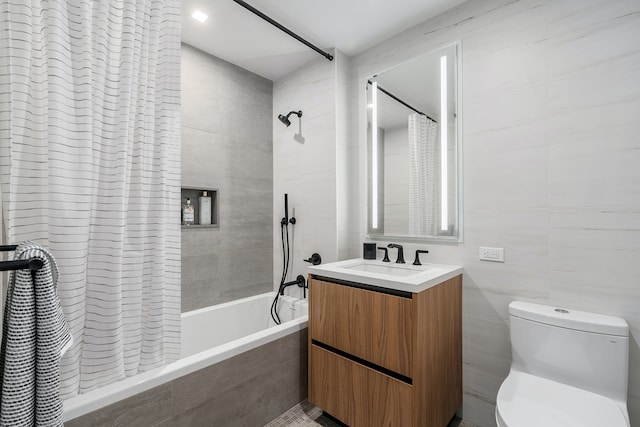 full bath featuring tiled shower / bath, toilet, tile walls, and vanity