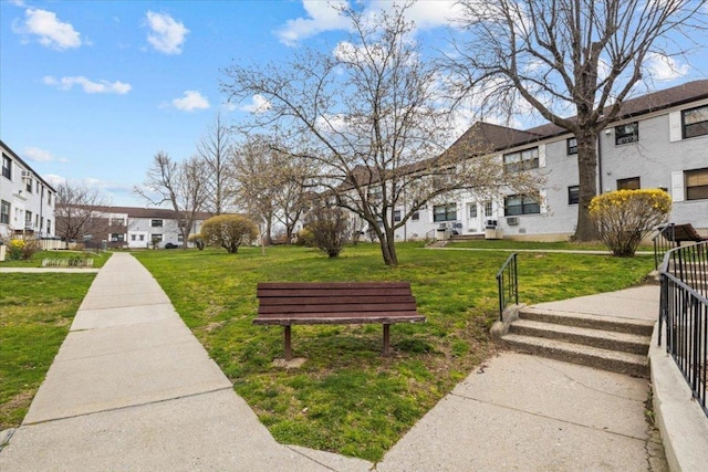 surrounding community with a lawn, fence, and a residential view