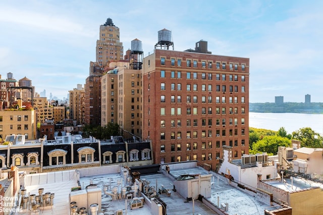 view of building exterior featuring a view of city and a water view