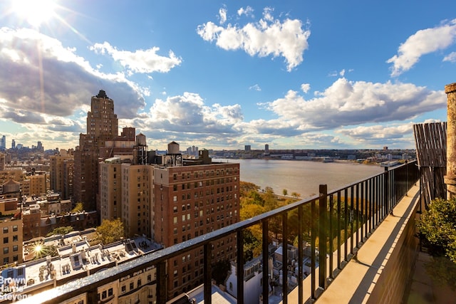 balcony featuring a city view and a water view