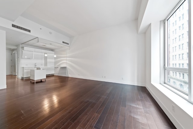 unfurnished living room with dark hardwood / wood-style flooring