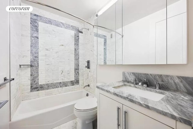 full bathroom with tiled shower / bath, vanity, and toilet