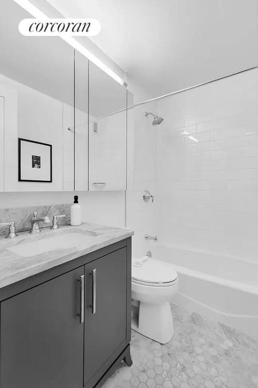 full bathroom with vanity, tiled shower / bath combo, and toilet