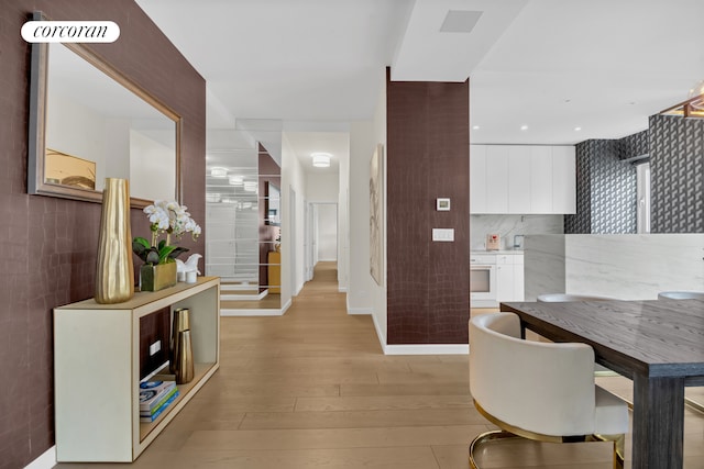 interior space featuring light wood finished floors and tile walls