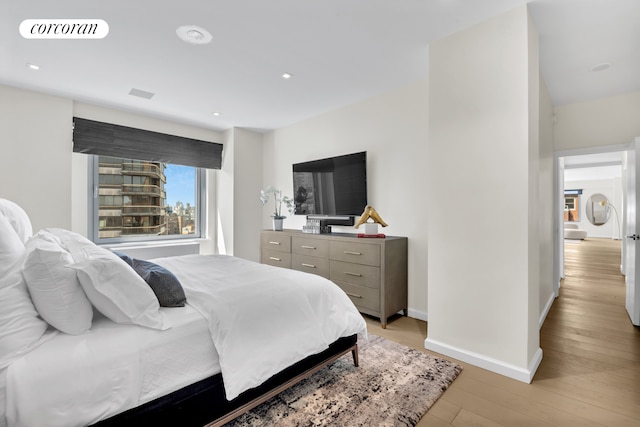 bedroom with recessed lighting, baseboards, visible vents, and light wood finished floors